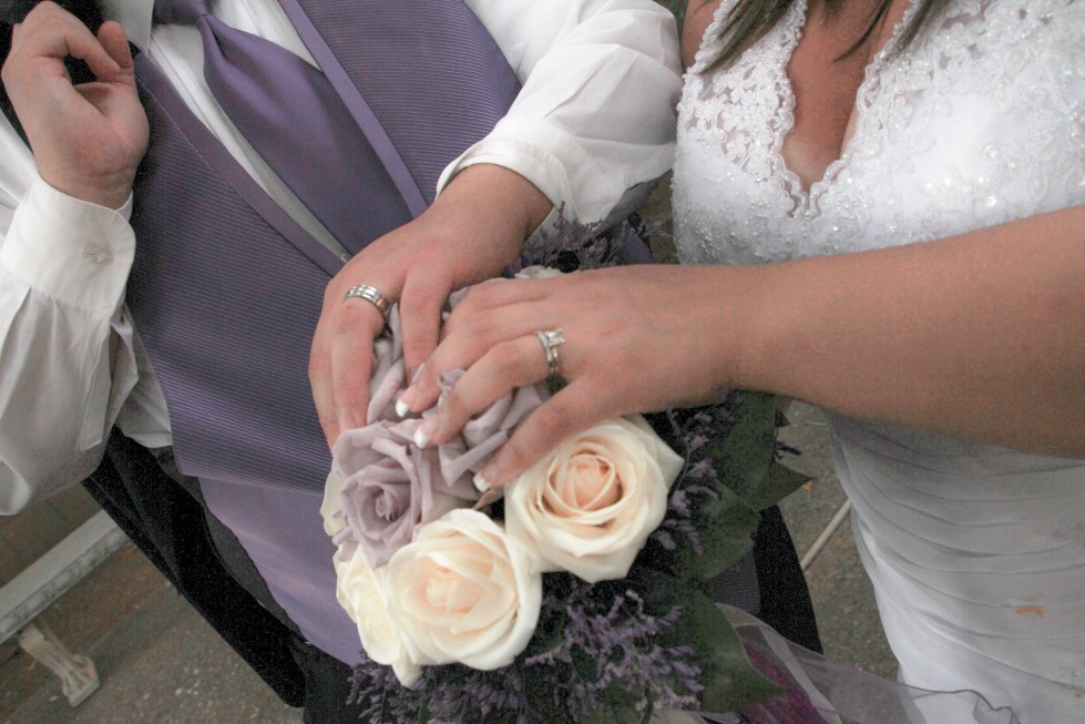 Chris and Melissa after the wedding with their rings on her bouquet.